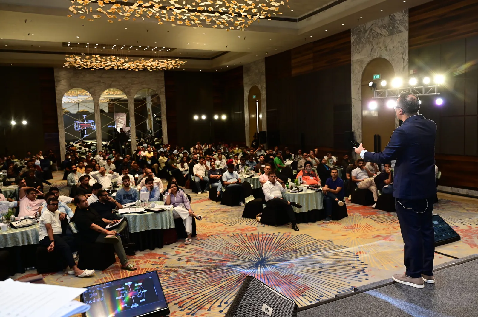 Wide view of packed Goa ballroom
